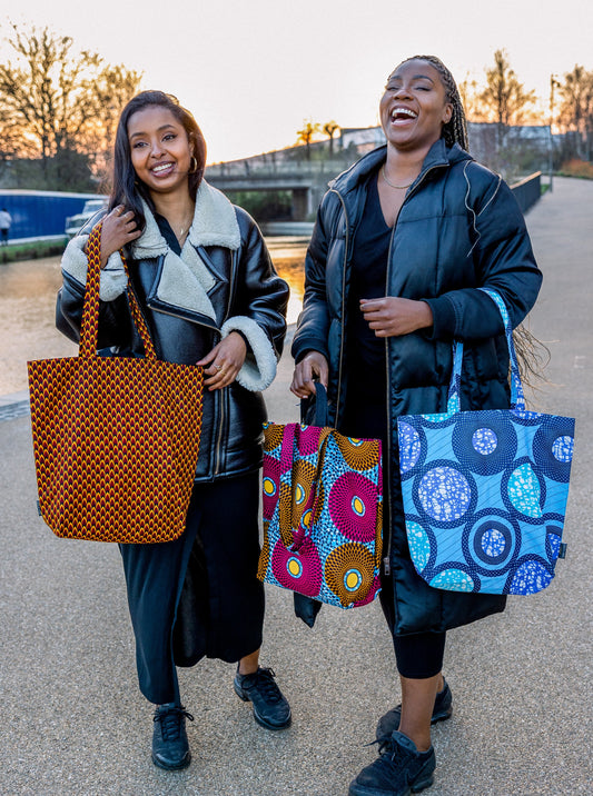 Models posing with Lolly and Kiks tote bags in different prints