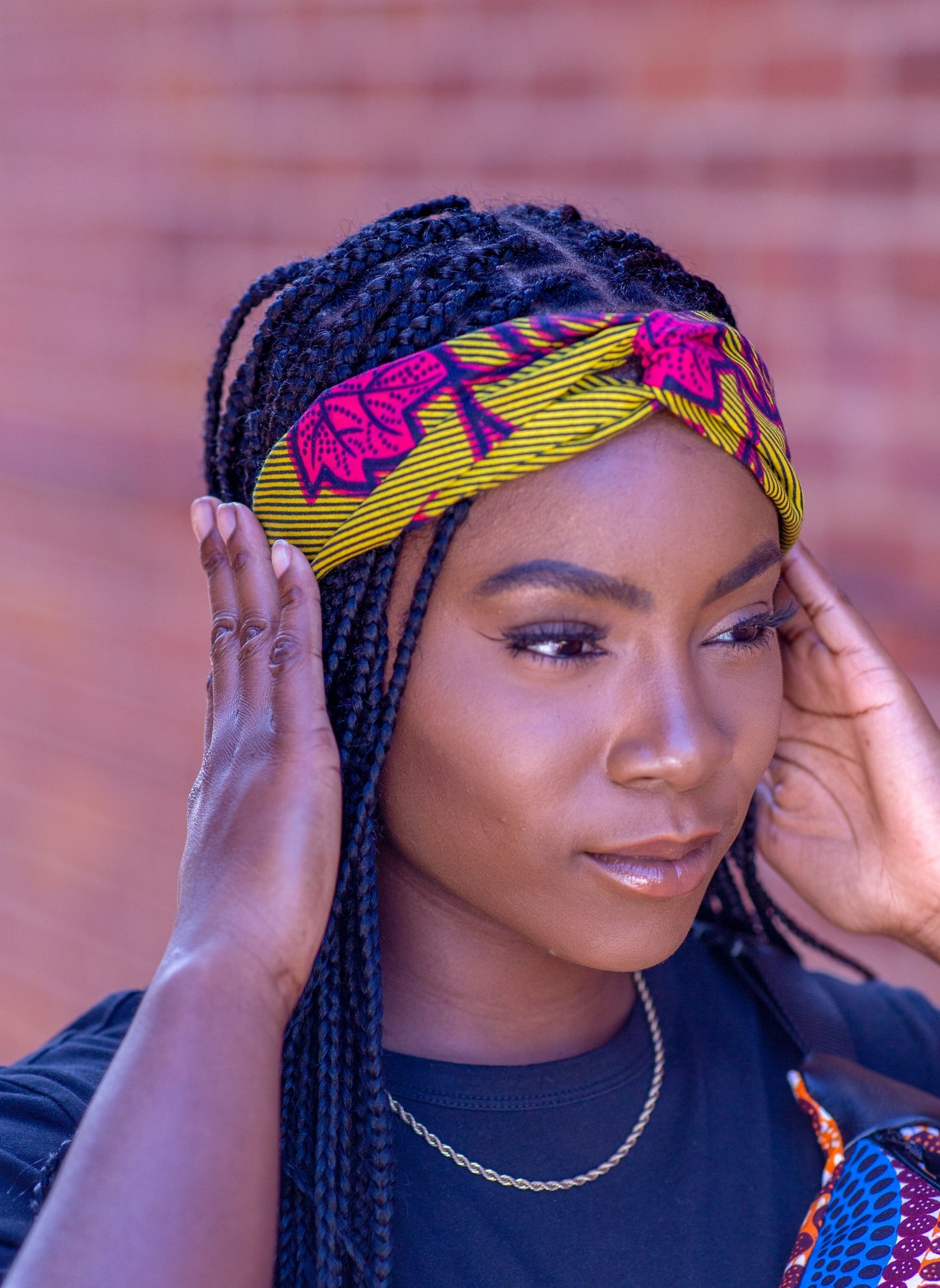 Black model wears yellow and pink Ife headband by Lolly and Kiks
