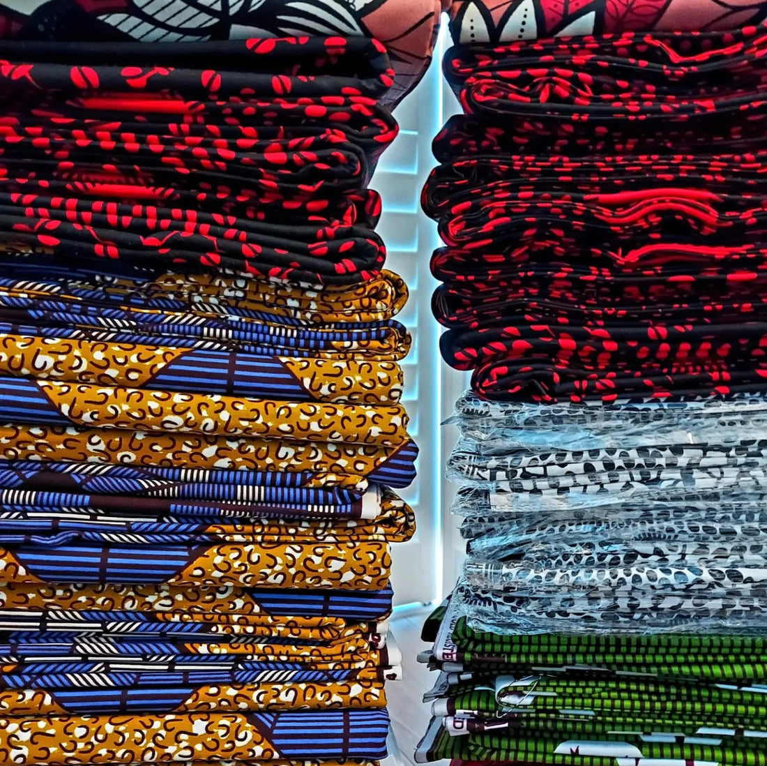 stack of african wax pint fabrics used to make bags and accessories in the UK