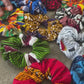 video of hands gathering together various colourful african print hair ties scrunchies