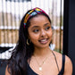 Model wears pink multicoloured headband in Bimpe print by Lolly and Kiks