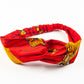Red Igbale headband by Lolly and Kiks on a white surface